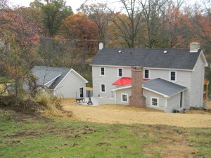 The back of the house, it all comes together with pop of color from the red tin roof over the laundry/mud room.